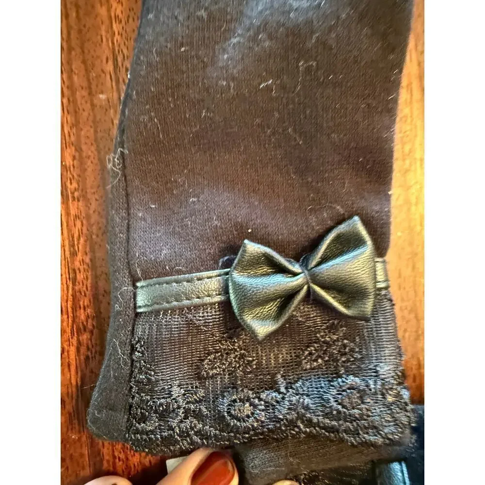 Black touchscreen compatible gloves with lace detail and faux leather bow. NWT